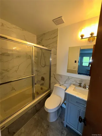 a bathroom with a toilet a sink and shower