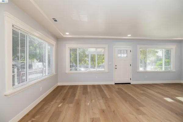 an empty room with a bathroom and a sink