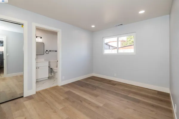 a kitchen with a sink a counter top space stainless steel appliances and a window