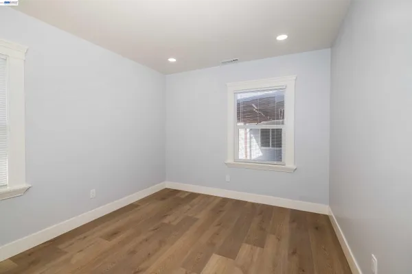 a bathroom with a granite countertop sink a toilet and mirror
