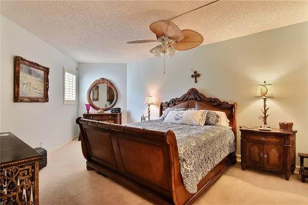 a bedroom with a bed and dresser with mirror