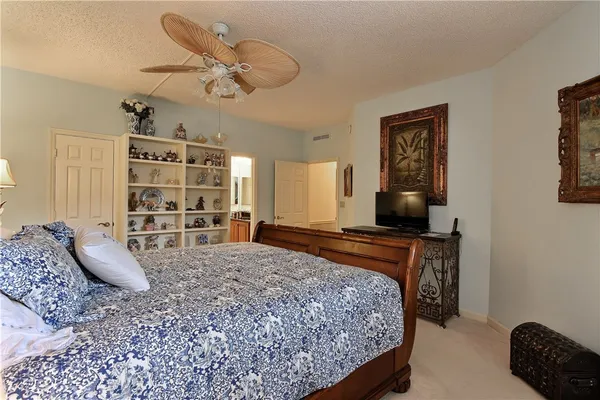 a bedroom with a bed a couch and dresser