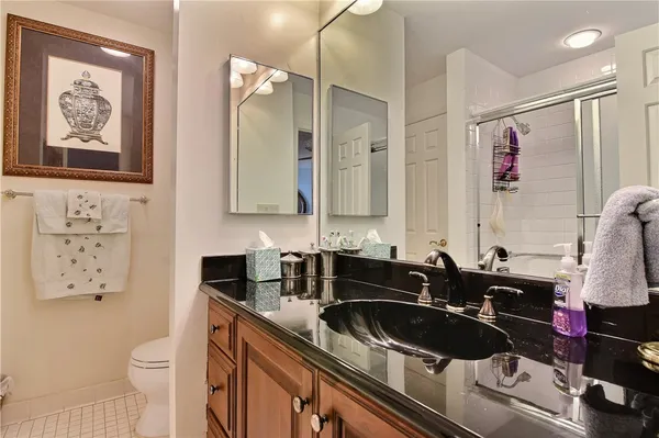 a bathroom with a sink a toilet and a mirror