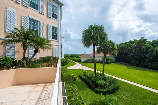 a view of a garden with a building in the background