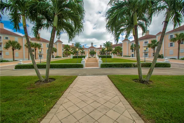 a view of a house with a swimming pool and sitting area
