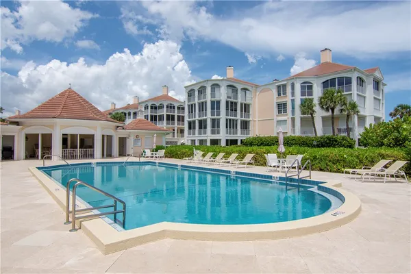 a view of a swimming pool with a yard