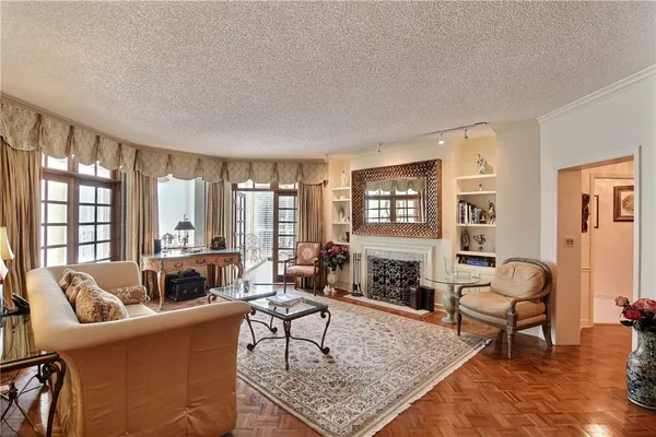 a living room with furniture large window and a fireplace