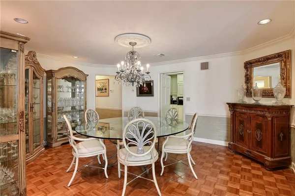 a view of a dining room with furniture and chandelier