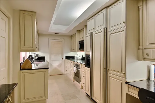 a kitchen with stainless steel appliances granite countertop cabinets and a refrigerator