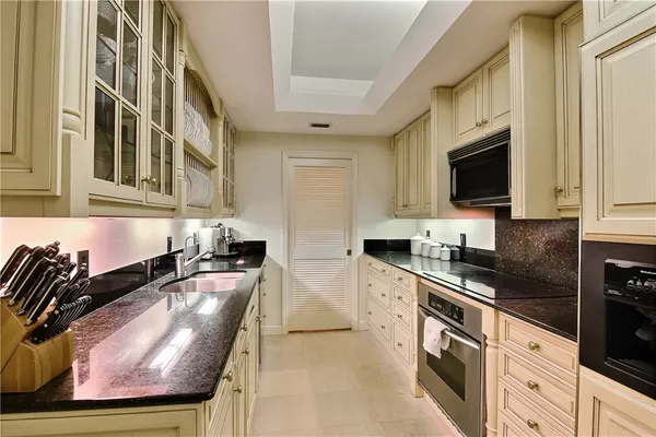 a kitchen with stainless steel appliances a sink a stove and a microwave