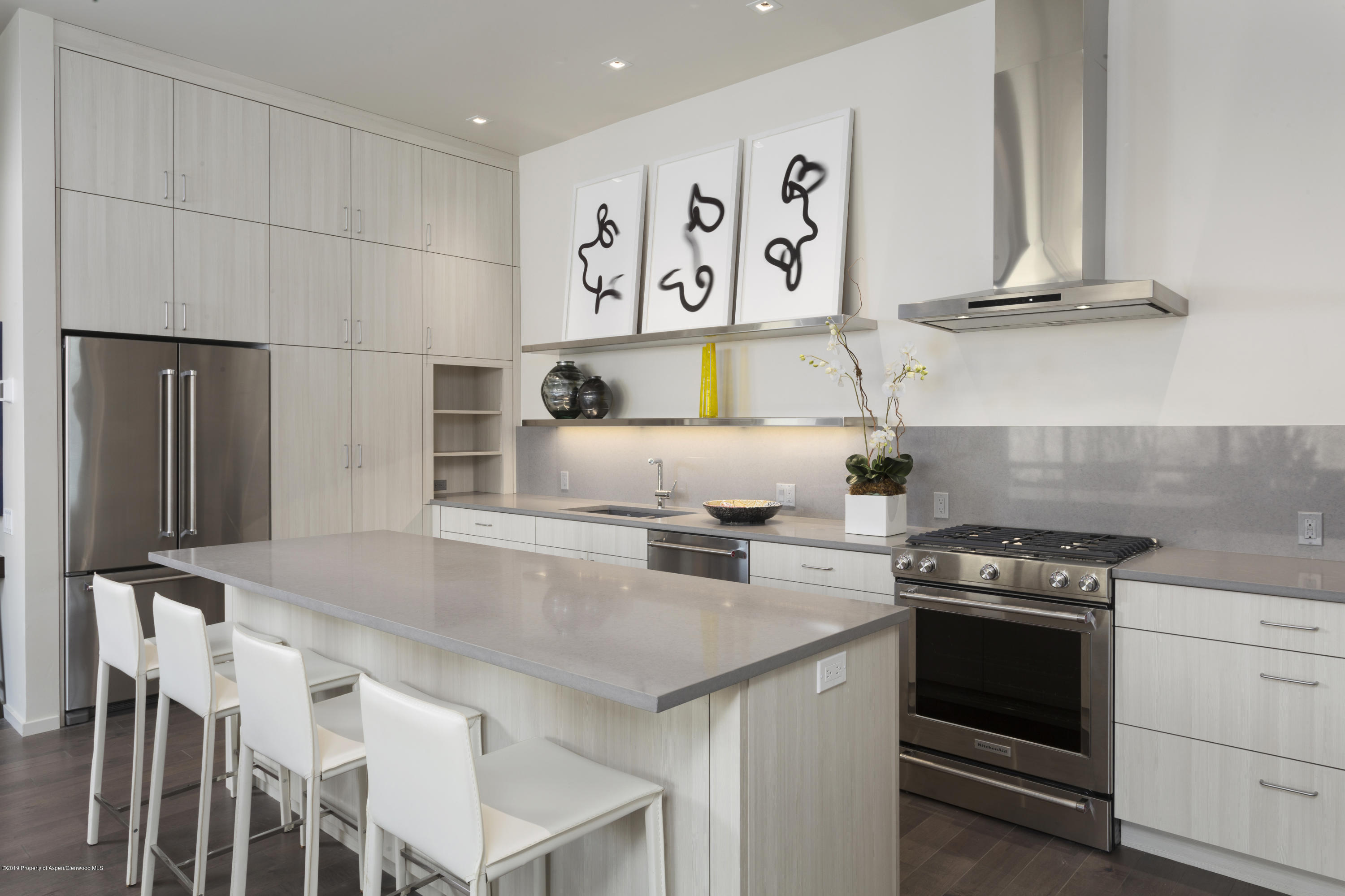 a kitchen with stainless steel appliances a stove a refrigerator and a cabinets
