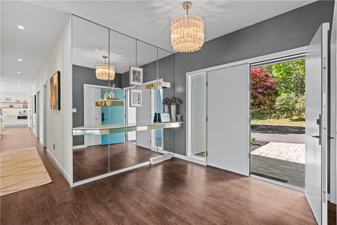 1506 Pleasant View Road Coopersburg, PA 18036 - Photo 10 of 97 A striking entry welcomes you with a mirrored accent wall and rich wood-toned flooring.