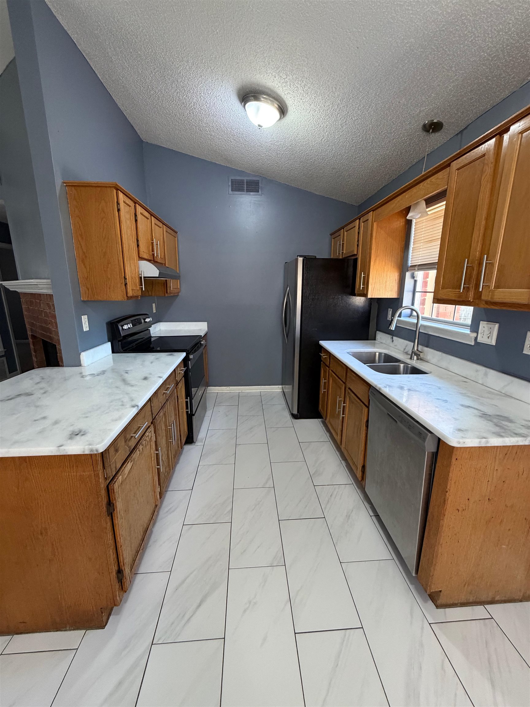 5901 Garden Ridge Drive Millington, TN 38053 - Photo 4 of 15 a kitchen with stainless steel appliances granite countertop a sink and a stove