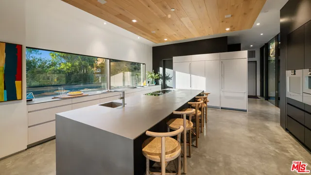 a large kitchen with a table and chairs