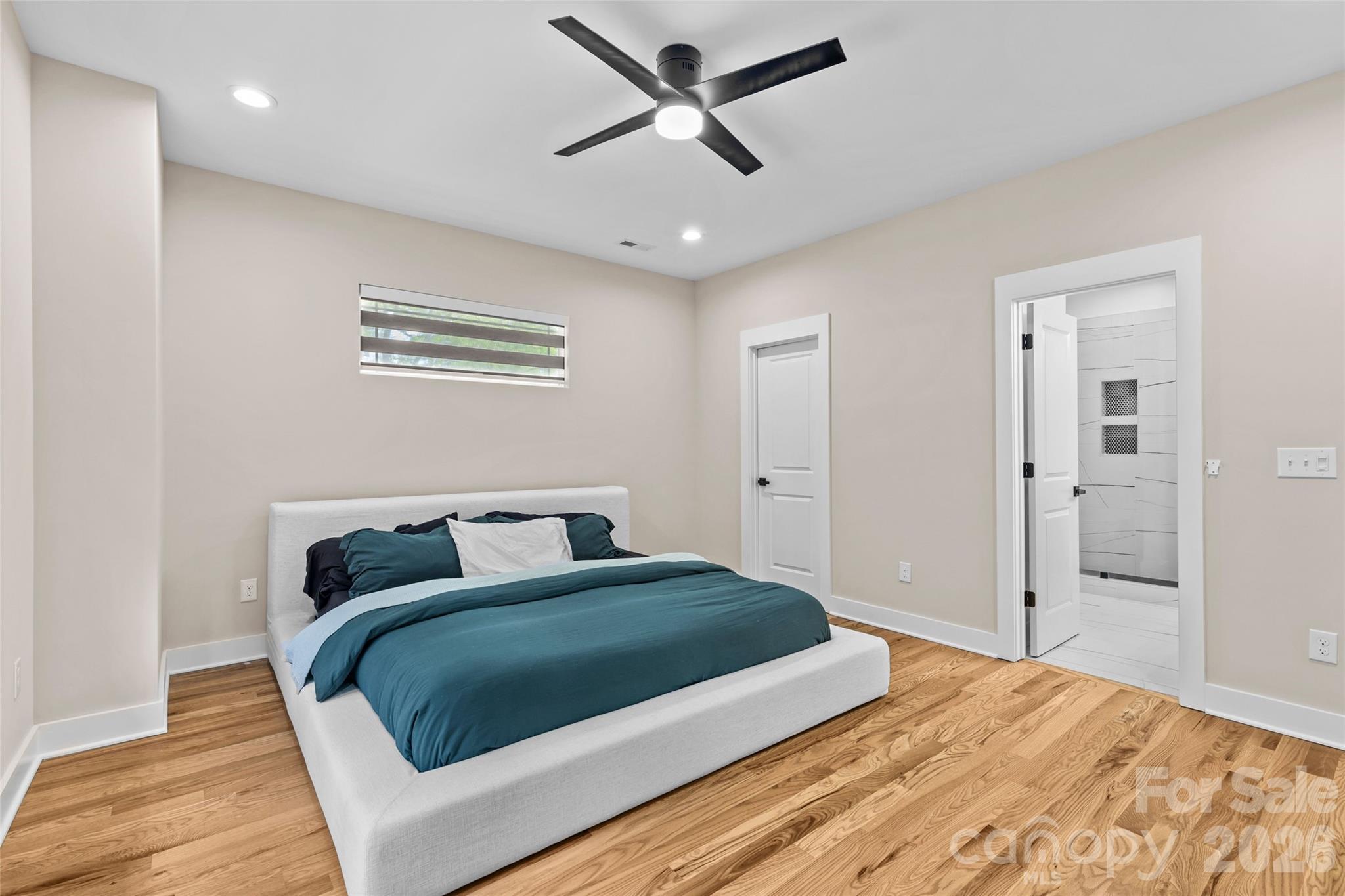 8925 Harrisburg Road Charlotte, NC 28215 - Photo 16 of 37 a bedroom with a bed and ceiling fan