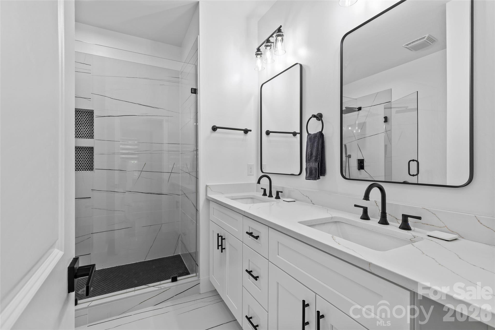 8925 Harrisburg Road Charlotte, NC 28215 - Photo 18 of 37 a bathroom with 2 sink and a mirror