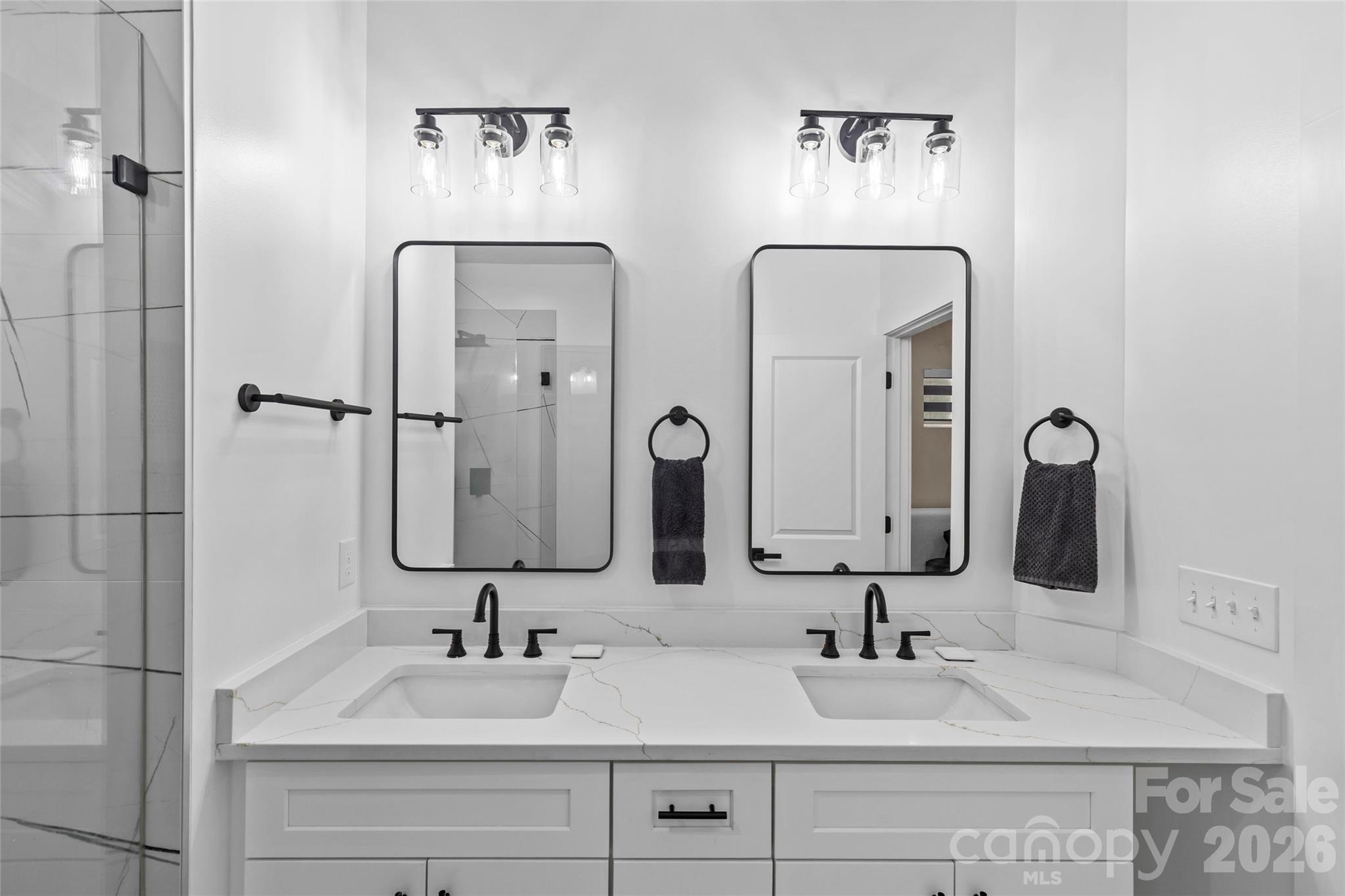 8925 Harrisburg Road Charlotte, NC 28215 - Photo 19 of 37 a bathroom with double vanity sinks and a mirror