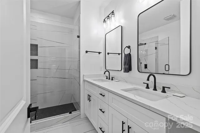 a bathroom with 2 sink and a mirror