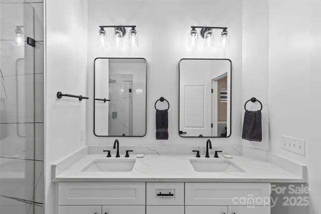 a bathroom with double vanity sinks and a mirror