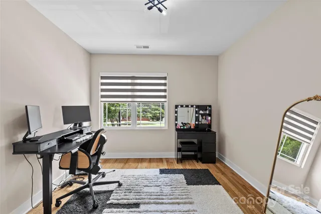 a view of a workspace with furniture and a window