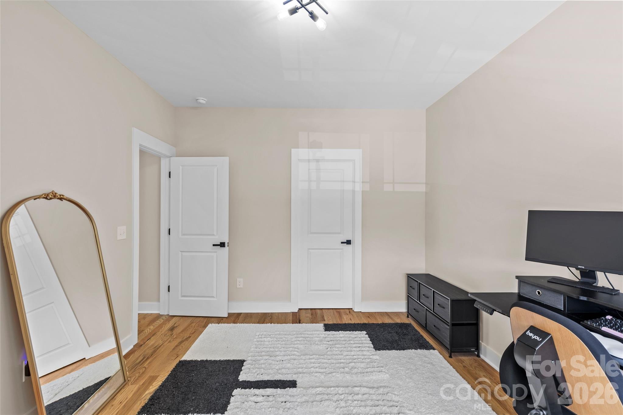 8925 Harrisburg Road Charlotte, NC 28215 - Photo 23 of 37 a bedroom with a bed and a flat tv screen on dresser