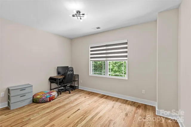 a room with wooden floor and gym equipment