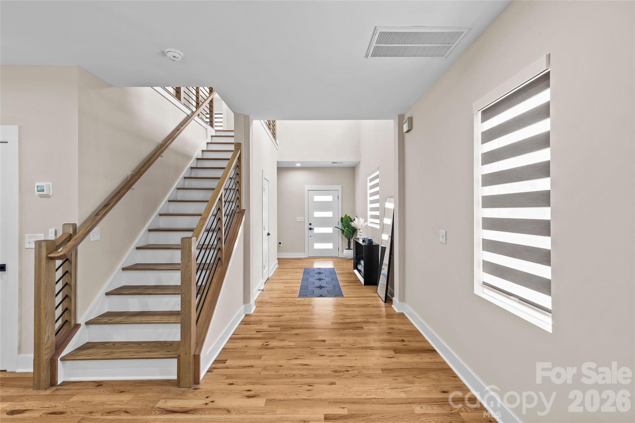 8925 Harrisburg Road Charlotte, NC 28215 - Photo 3 of 37 a view of a hallway with wooden floor and windows