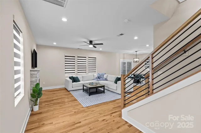 a living room with furniture and wooden floor