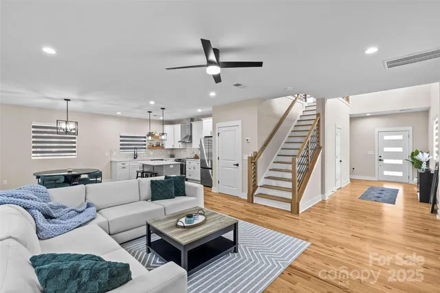 a living room with furniture and wooden floor