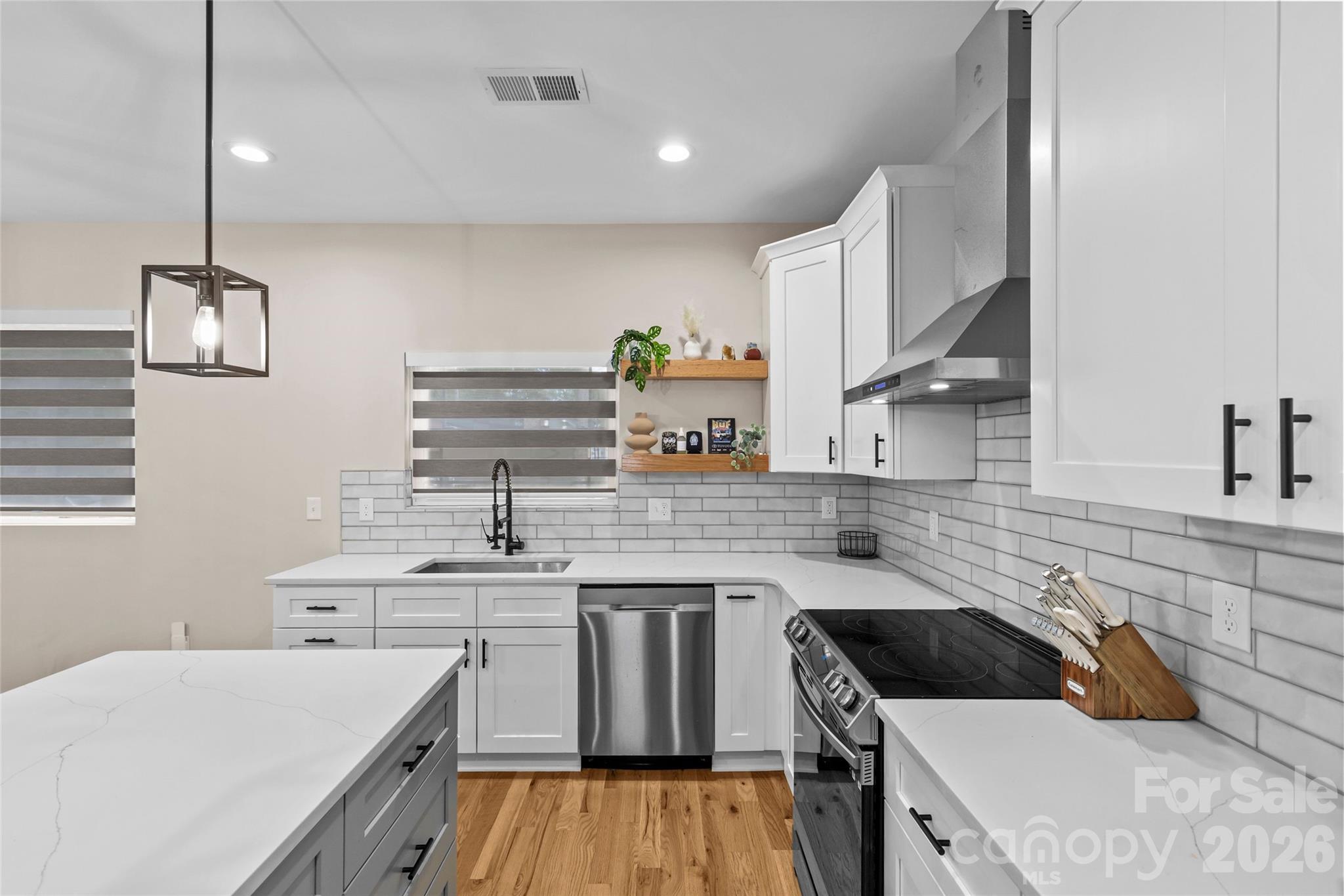 8925 Harrisburg Road Charlotte, NC 28215 - Photo 9 of 37 a kitchen with a sink a stove and cabinets
