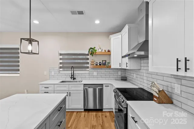 a kitchen with a sink a stove and cabinets