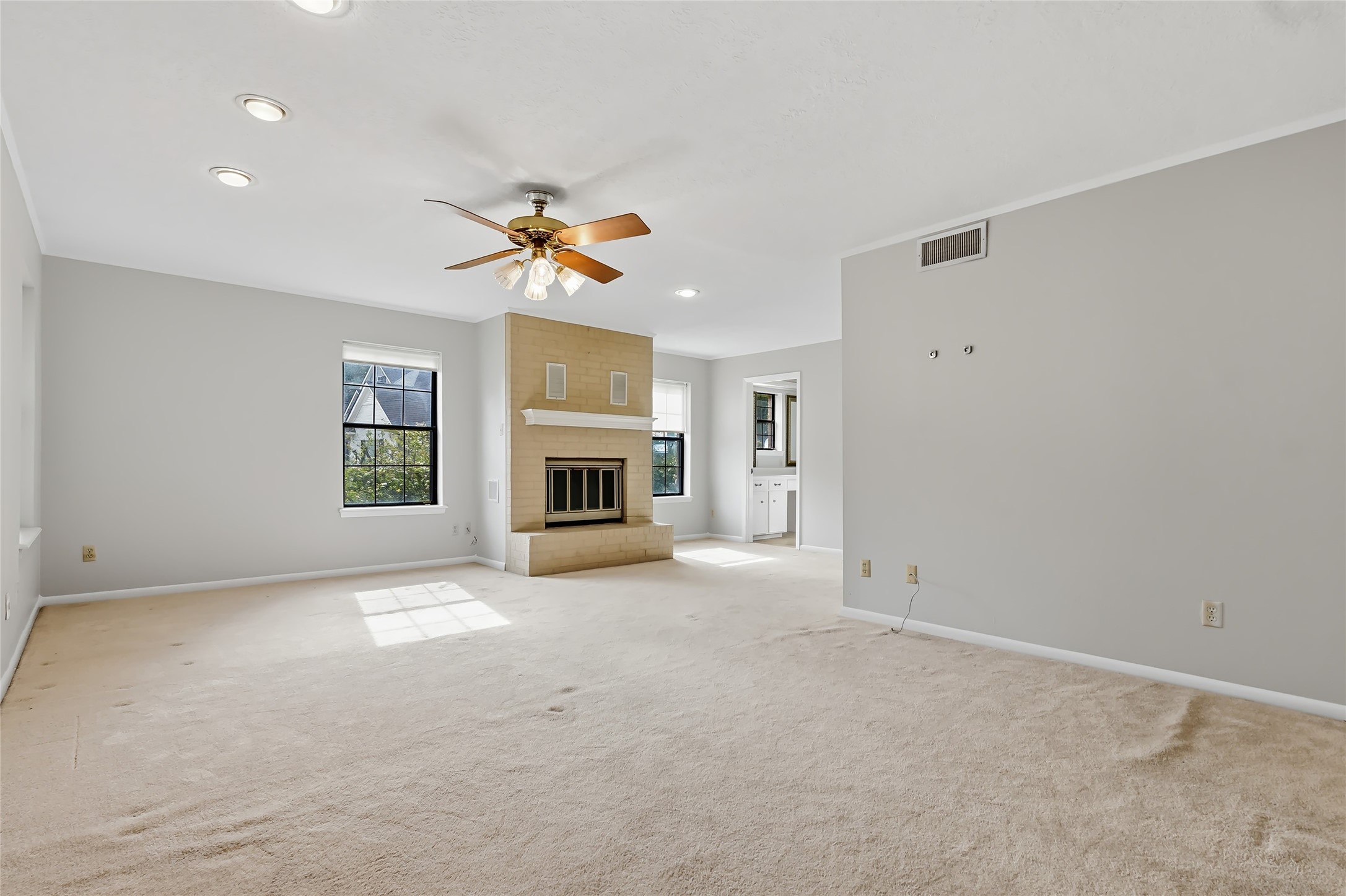 807 Standley Road Madisonville, TX 77864 - Photo 29 of 35 an empty room with windows and fireplace