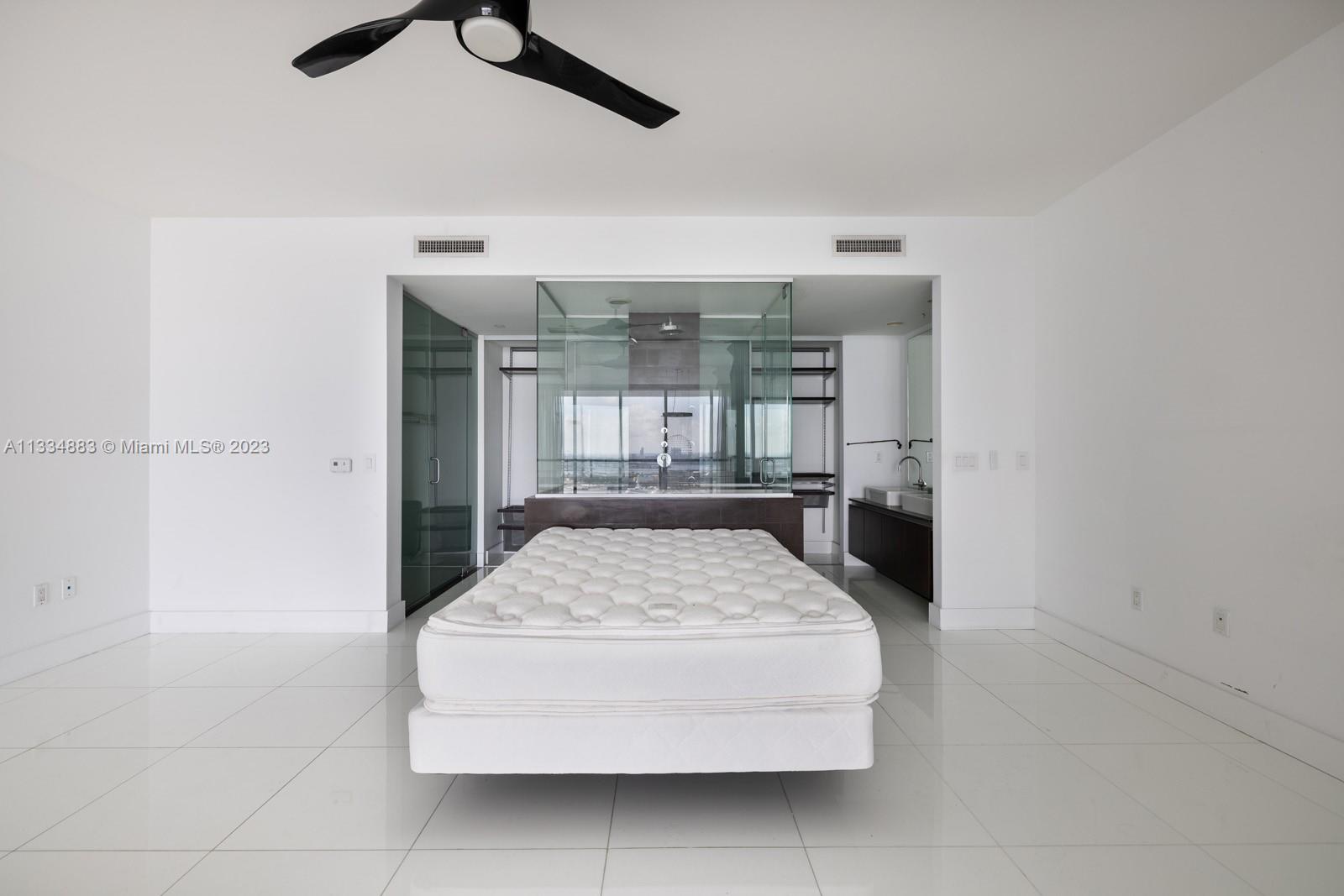 1040 Biscayne Boulevard, Unit 2402 Miami, FL 33132 - Photo 14 of 25 a living room with a couch and chandelier