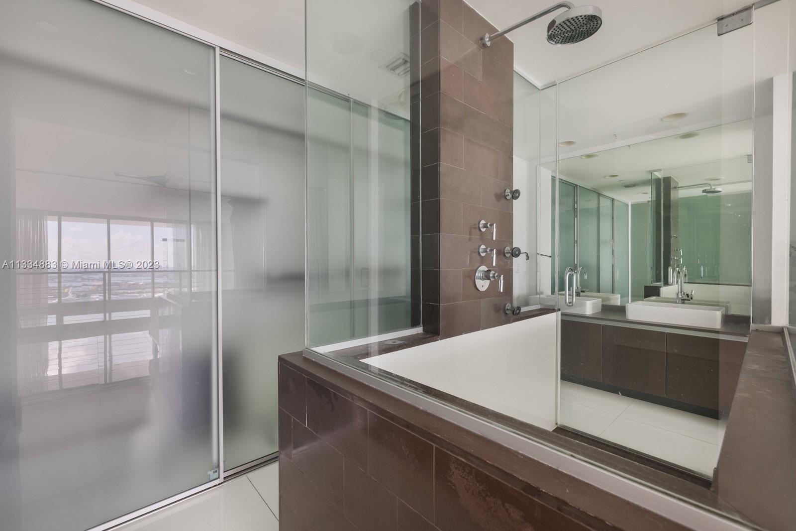 1040 Biscayne Boulevard, Unit 2402 Miami, FL 33132 - Photo 16 of 25 a view with granite countertop a refrigerator and a sink