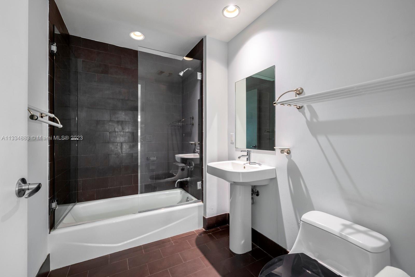 1040 Biscayne Boulevard, Unit 2402 Miami, FL 33132 - Photo 18 of 25 a bathroom with a sink toilet and shower