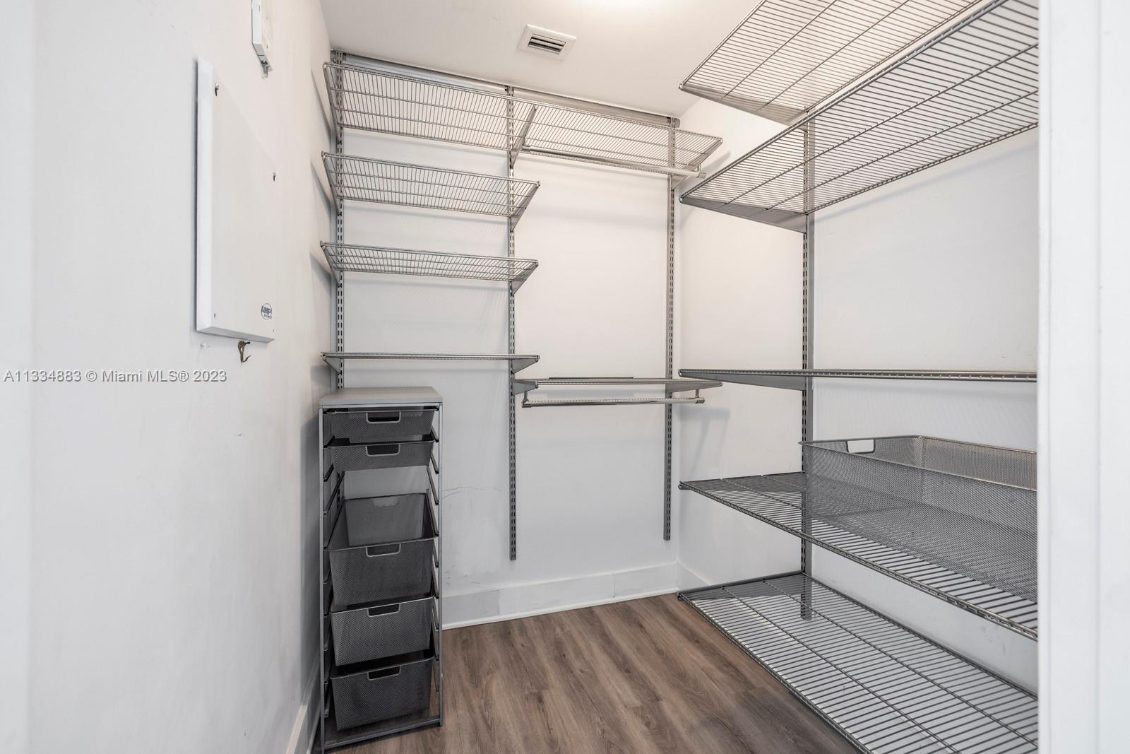 1040 Biscayne Boulevard, Unit 2402 Miami, FL 33132 - Photo 19 of 25 a view of walk in closet with empty racks