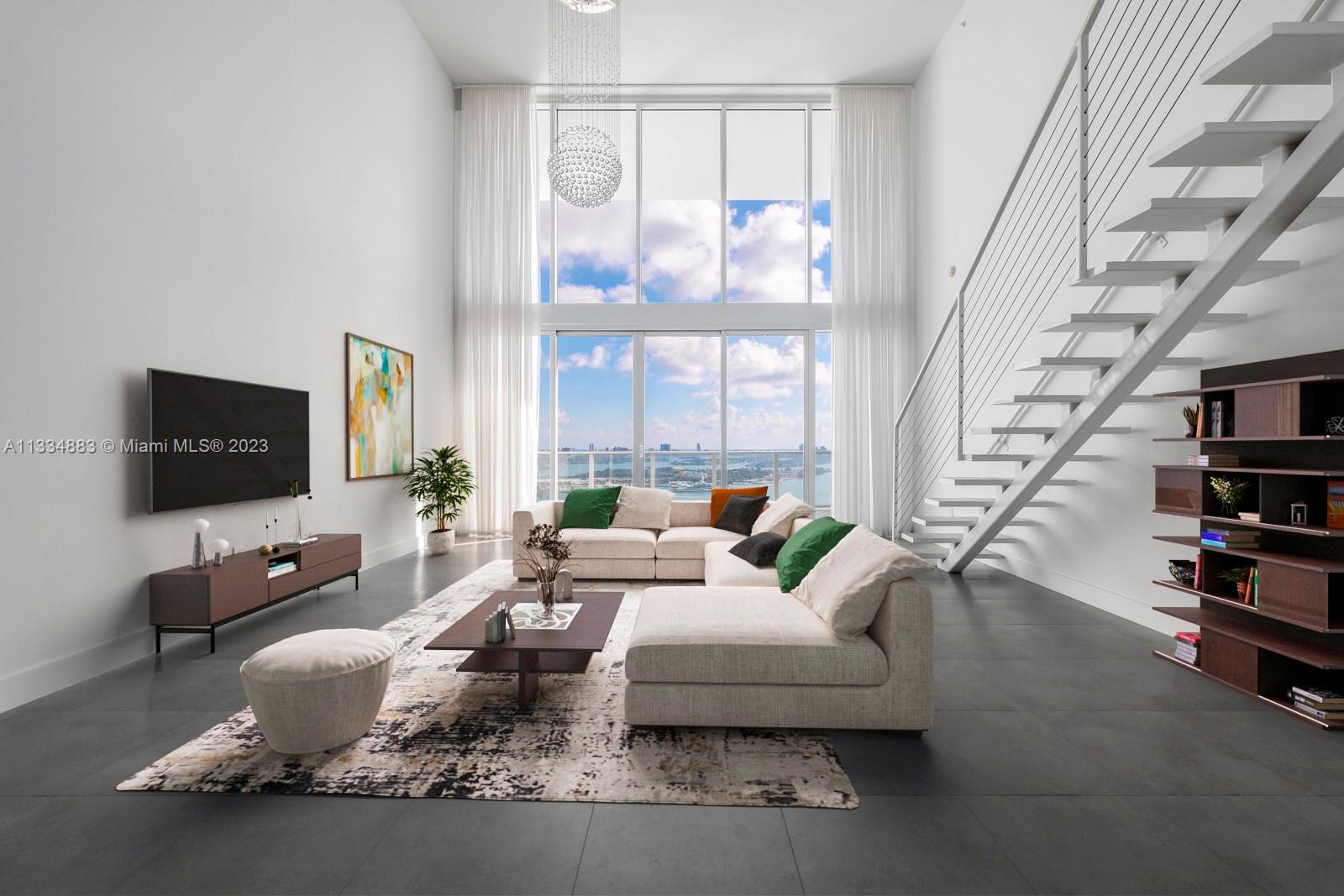 1040 Biscayne Boulevard, Unit 2402 Miami, FL 33132 - Photo 3 of 25 a living room with furniture wooden floor and a flat screen tv