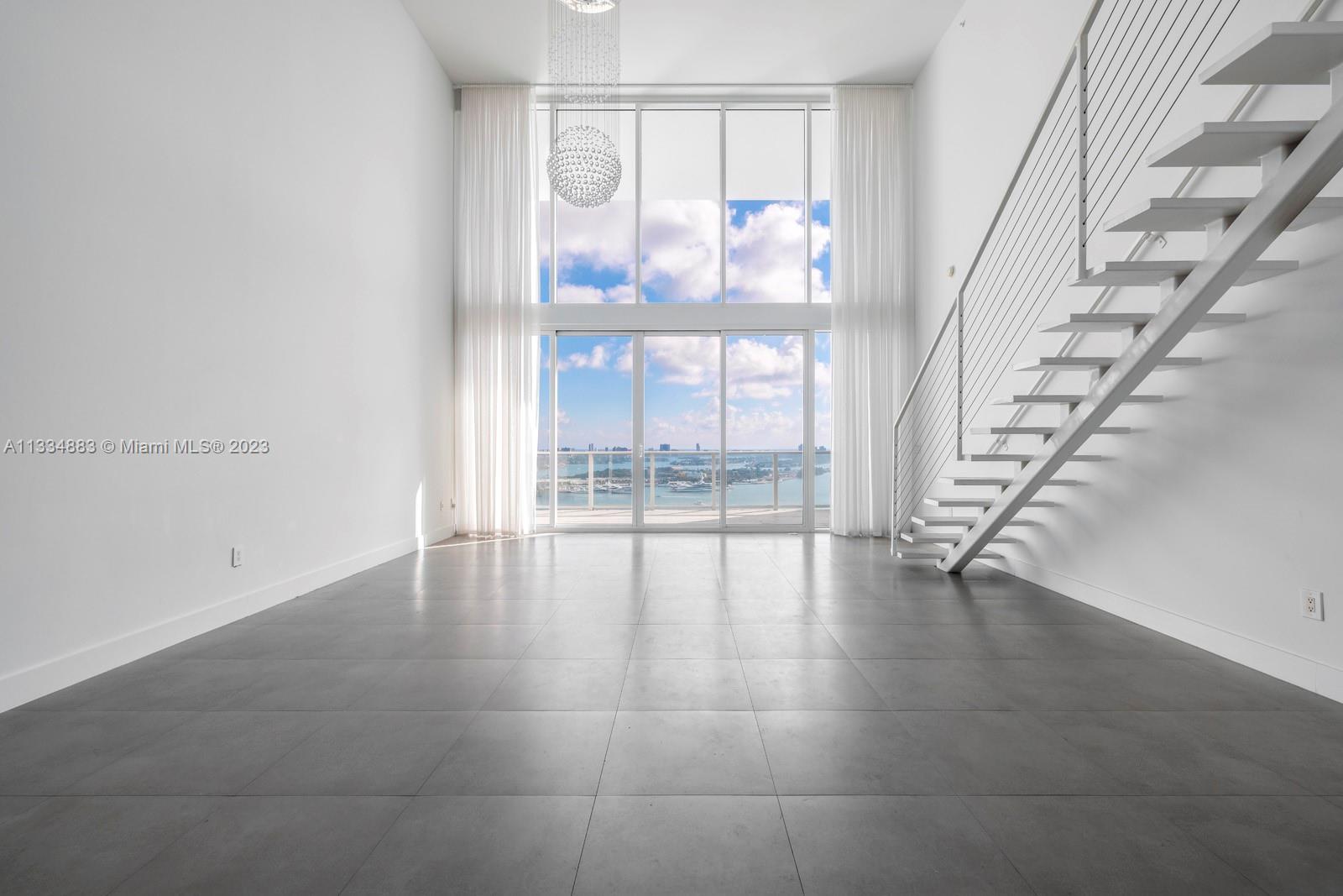 1040 Biscayne Boulevard, Unit 2402 Miami, FL 33132 - Photo 4 of 25 a view of an entryway with wooden floor
