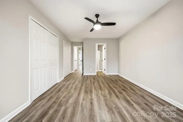 a view of empty room with wooden floor