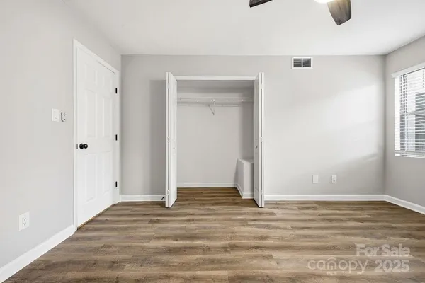 a view of room with window and hardwood floor