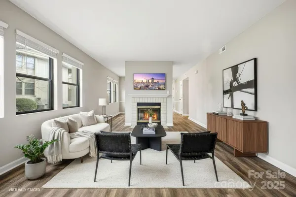 a living room with furniture a fireplace with wooden floor