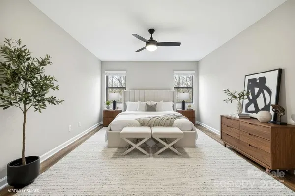 a bedroom with furniture and a potted plant