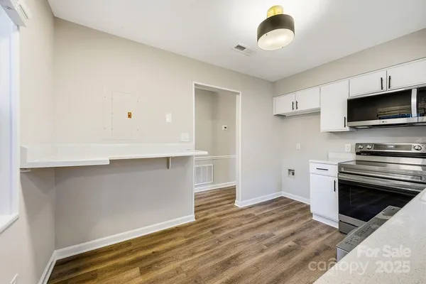 a kitchen with a stove and a microwave