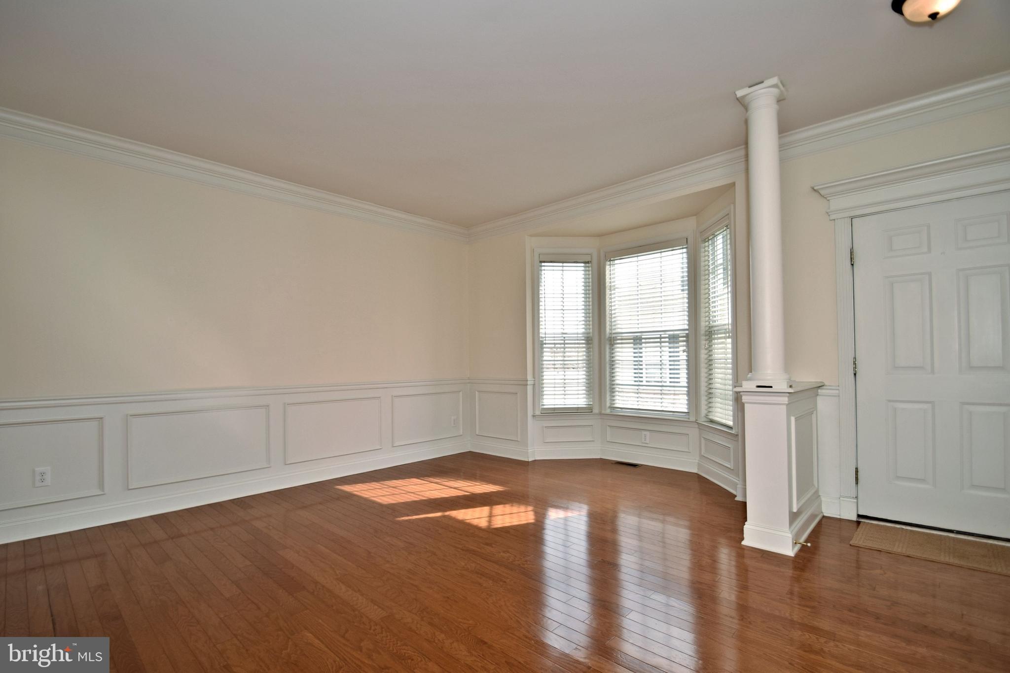 10 Wellington Road Newtown, PA 18940 - Photo 3 of 24 Living room with wainscoting & crown molding
