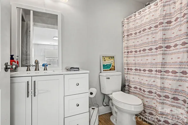 a kitchen with a refrigerator a stove and a wooden floor