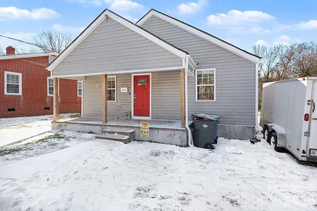 a living room with furniture a flat screen tv and a couch