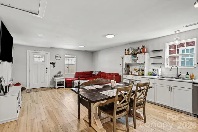 a kitchen with stainless steel appliances a stove a sink dishwasher and a refrigerator