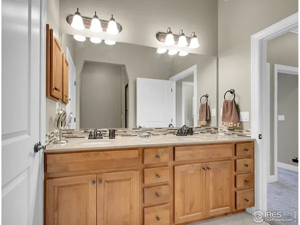 a bathroom with a double vanity sink and a mirror