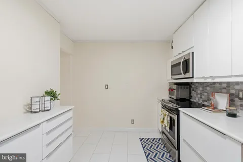 a kitchen with a sink and steel appliances