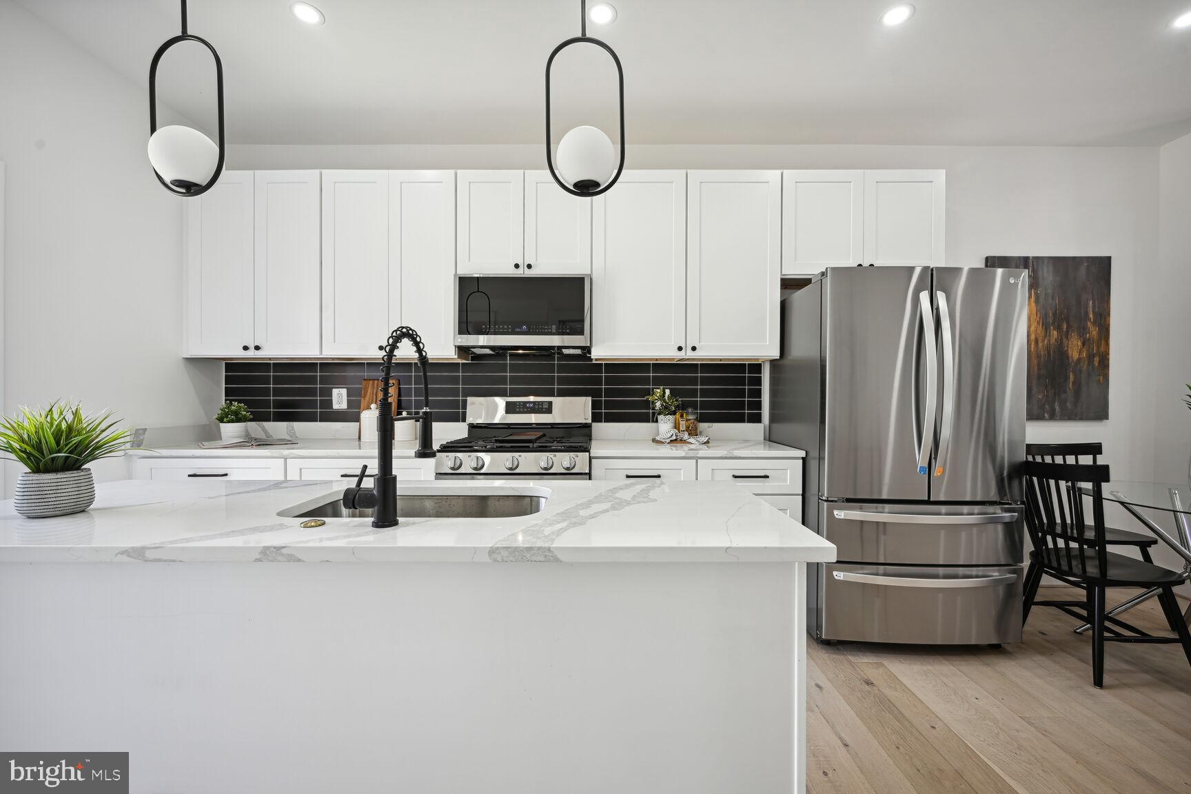 1111 6th Street Northeast Washington, DC 20002 - Photo 6 of 25 a kitchen with appliances a counter space and a sink